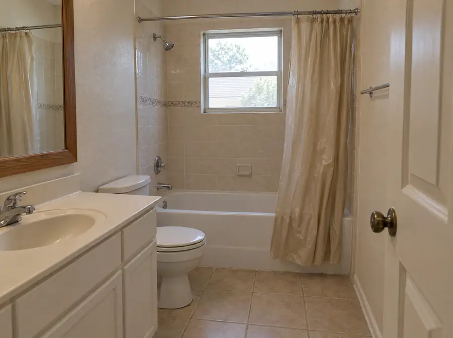 Before: a bathtub with a shower curtain
